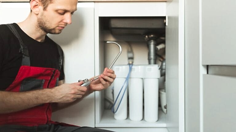 Plumber In The Kitchen Installs Tap For Household Water Purification System Plumber In The Kitchen Installs Tap For Household Water Purification System